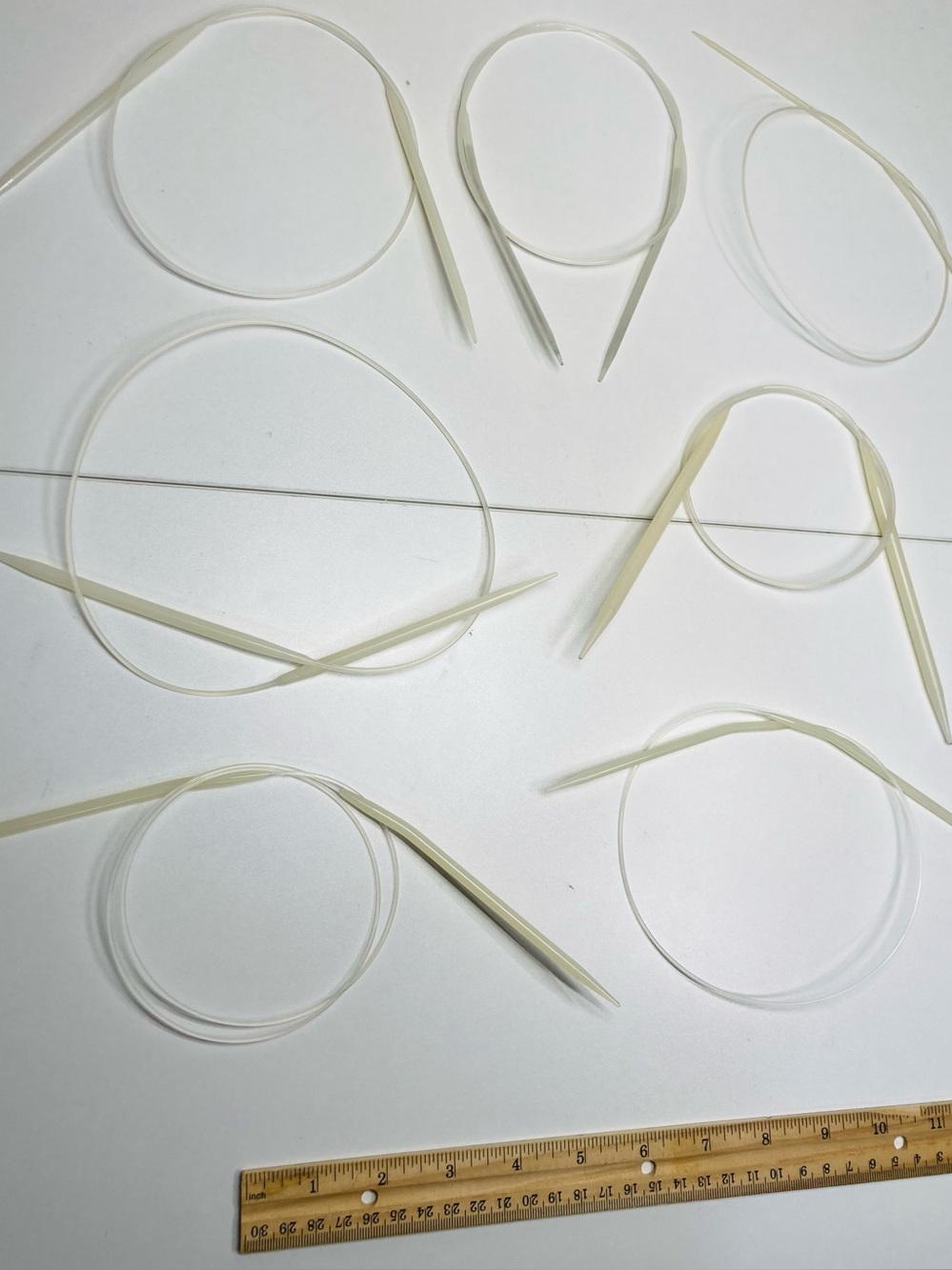 7 Circular Plastic Knitting Needles: Ivory color, Clear Cables, Different Sizes